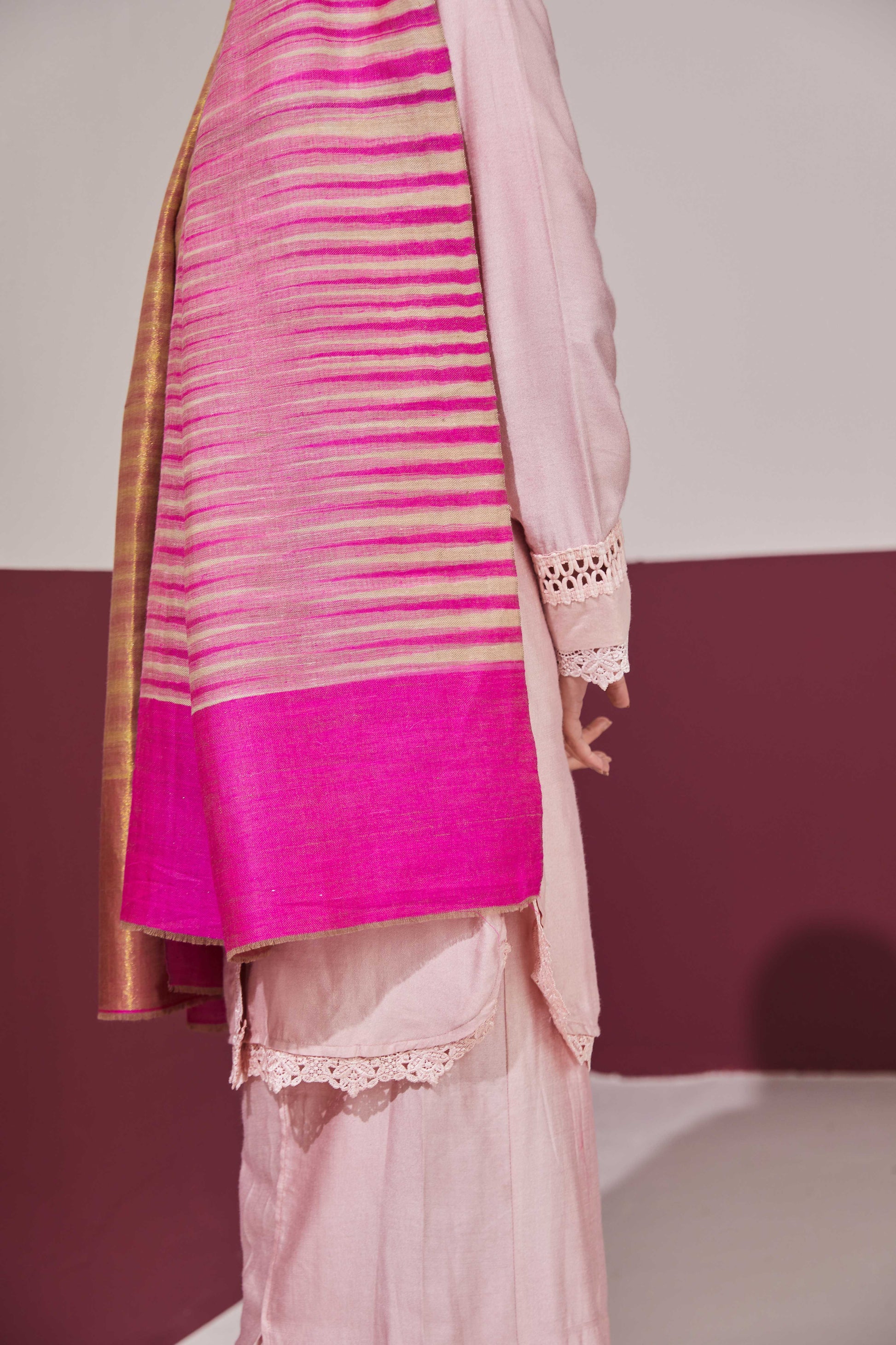 Model is wearing an Ekkat reversible stole in rani pink from Shaza.