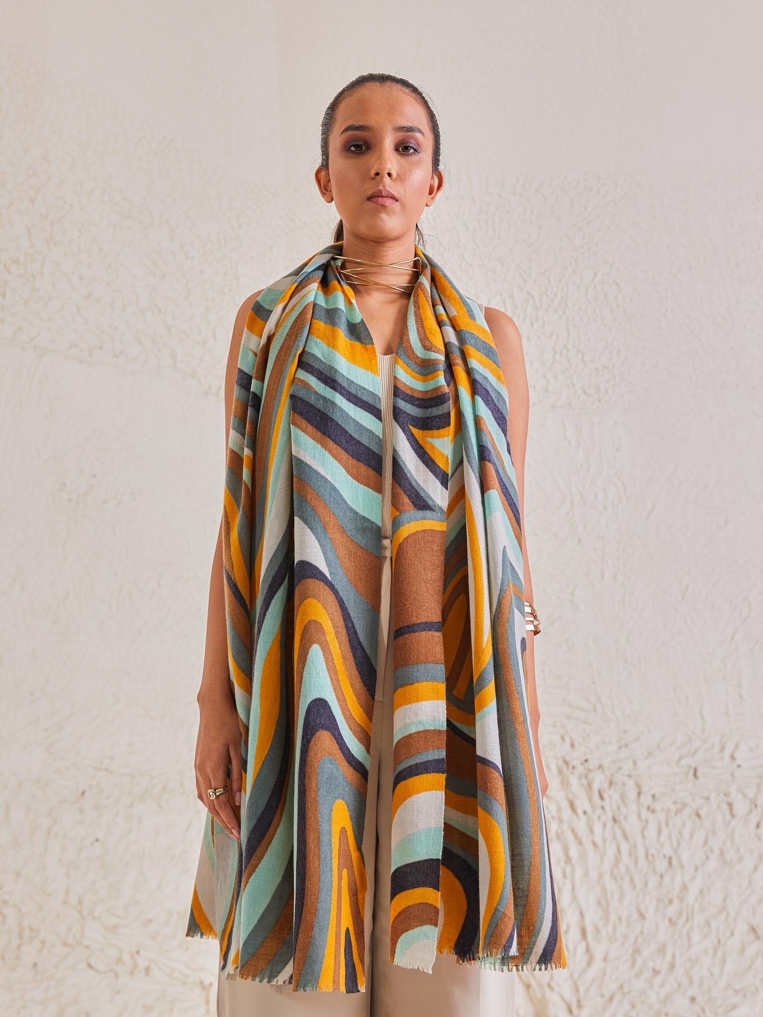 Model is wearing the disruption pashmina stole from shaza, handpainted in colours of brown, ochre and blue symbolizing Earth.