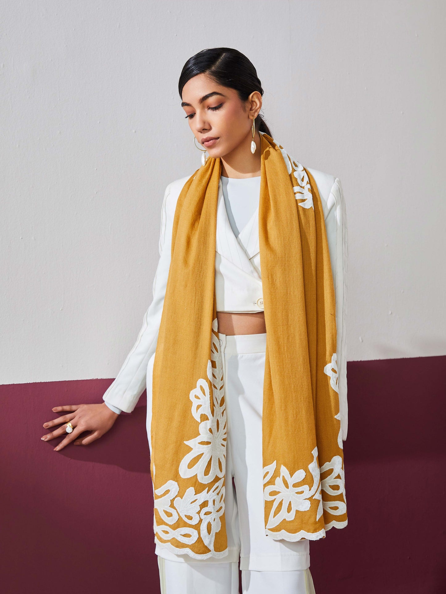 Model is wearing a mustard Velvet affair cashmere stole with white applique from Shaza.