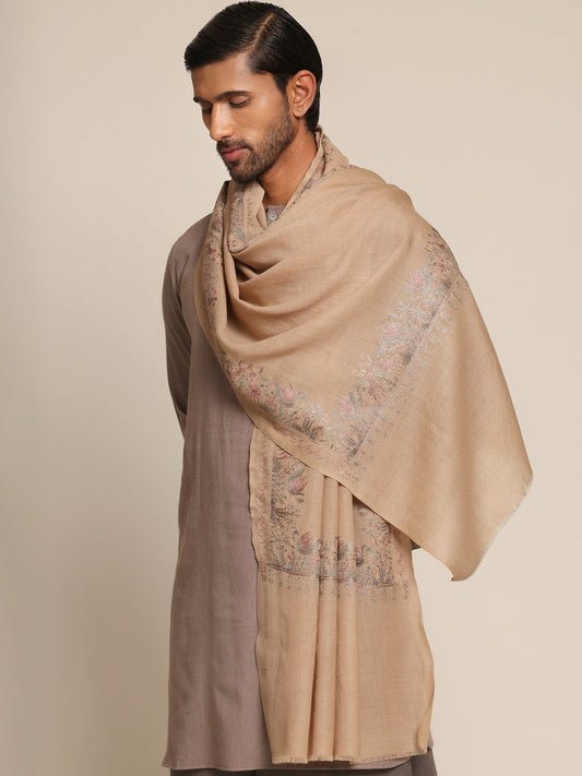 Man wearing a beige stole and brown outfit