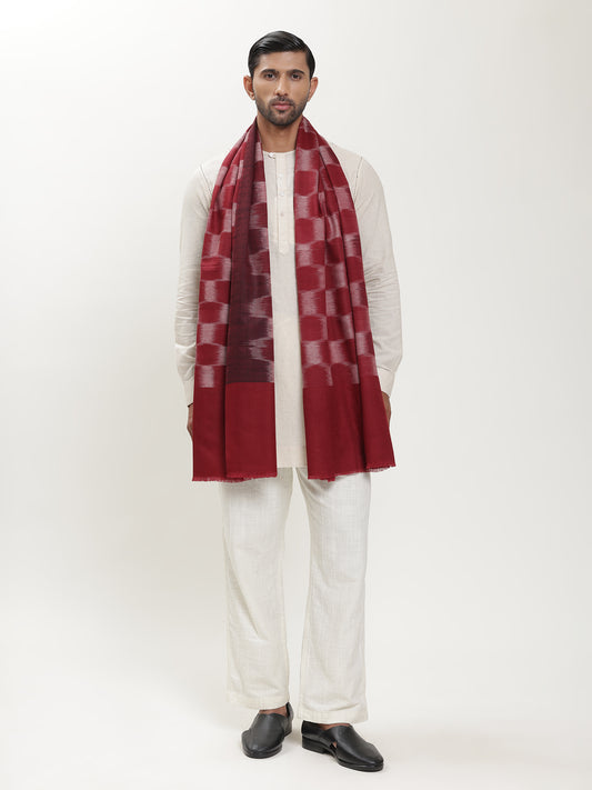 Man wearing a maroon and white patterned ikat stole