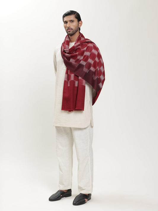 Man wearing a maroon and white patterned ikat stole