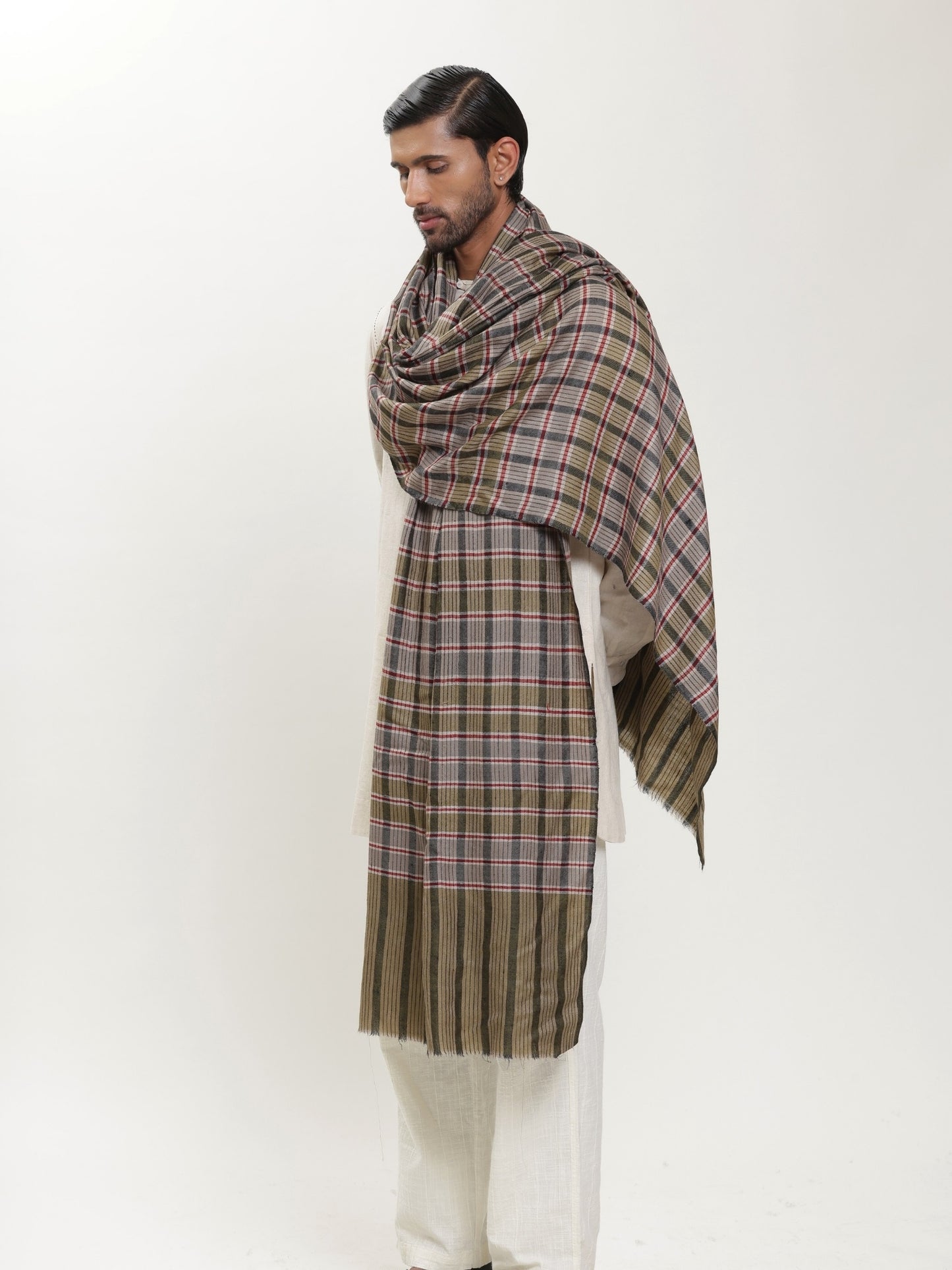 Man wearing a check shawl