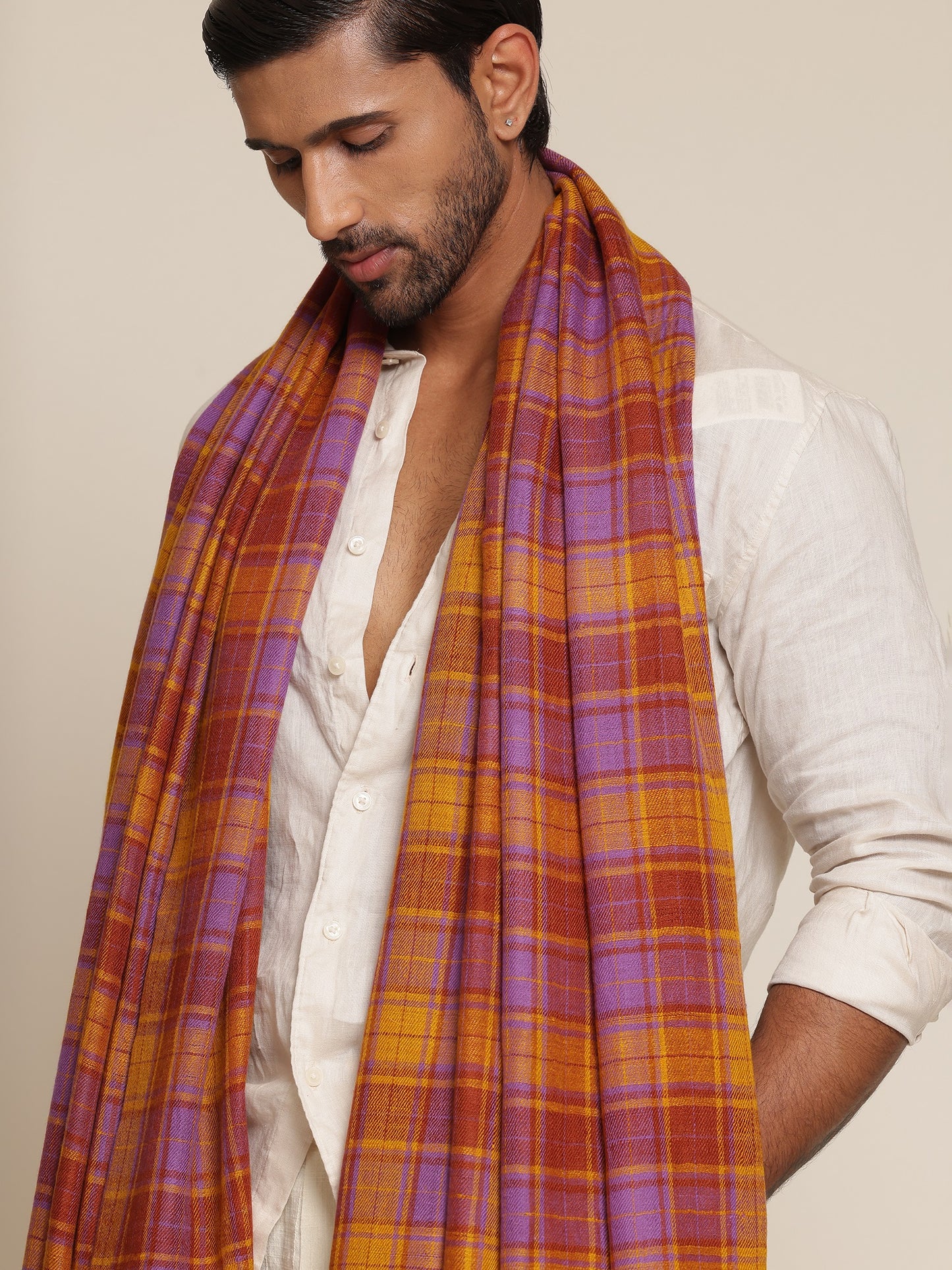 Man wearing a check shawl