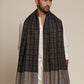 Man wearing a black and gray check stole