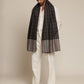 Man wearing a black and gray check stole