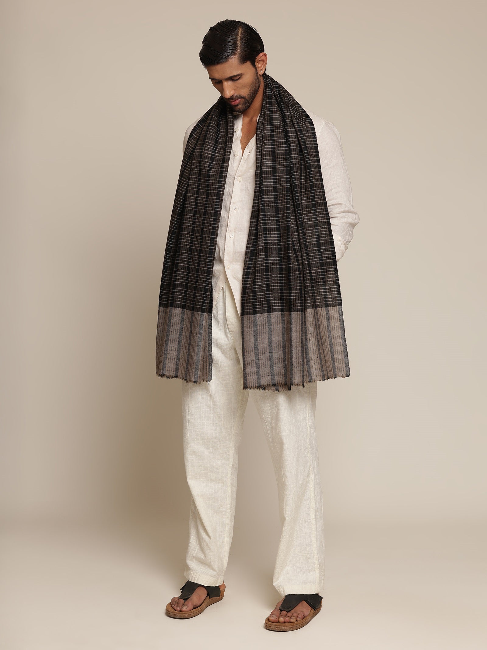 Man wearing a black and gray check stole