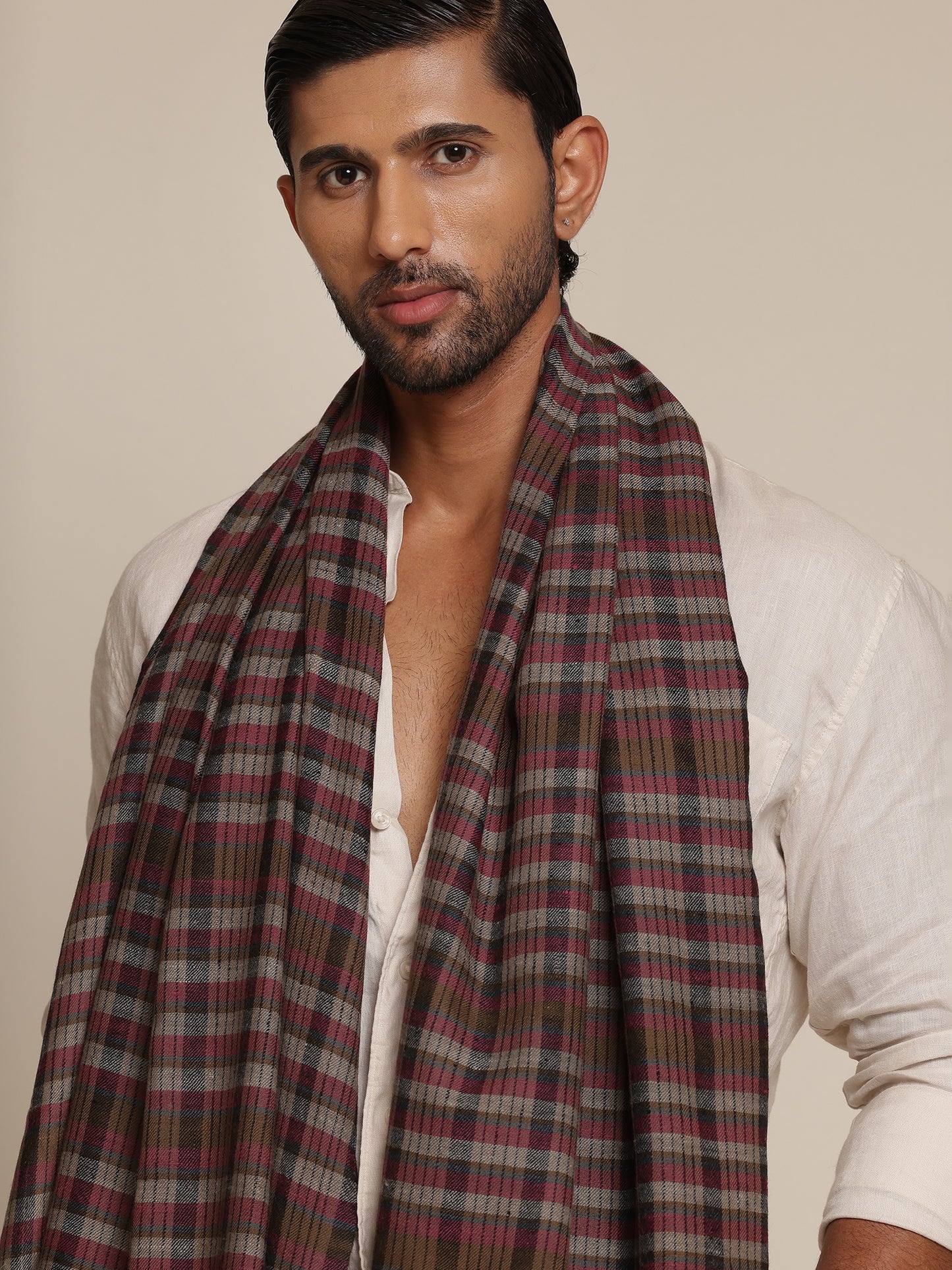 Man wearing a check stole