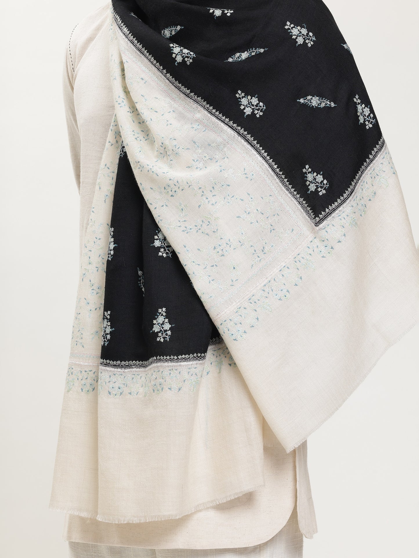 Man wearing a black and white pashmina shawl