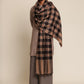 Man wearing a beige and black checkered Shawl