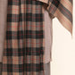 Man wearing a beige and black checkered Shawl