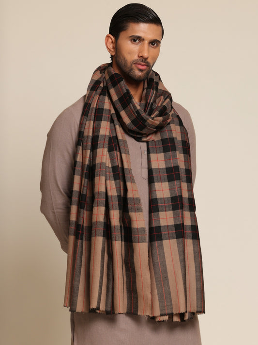 Man wearing a beige and black checkered Shawl