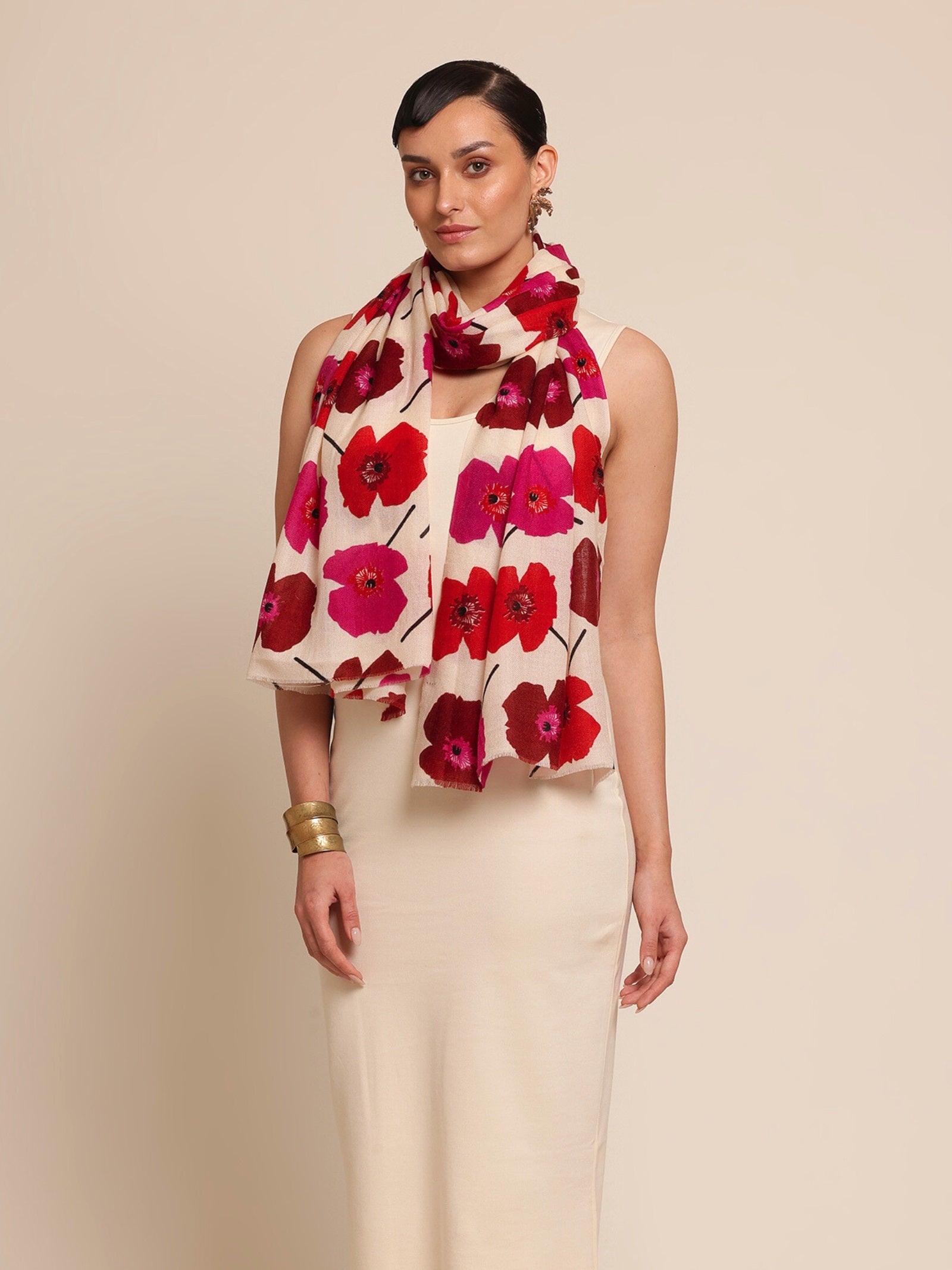 Woman wearing a floral stole with red and pink flowers 