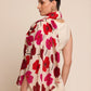 Woman wearing a floral stole with red and pink flowers 