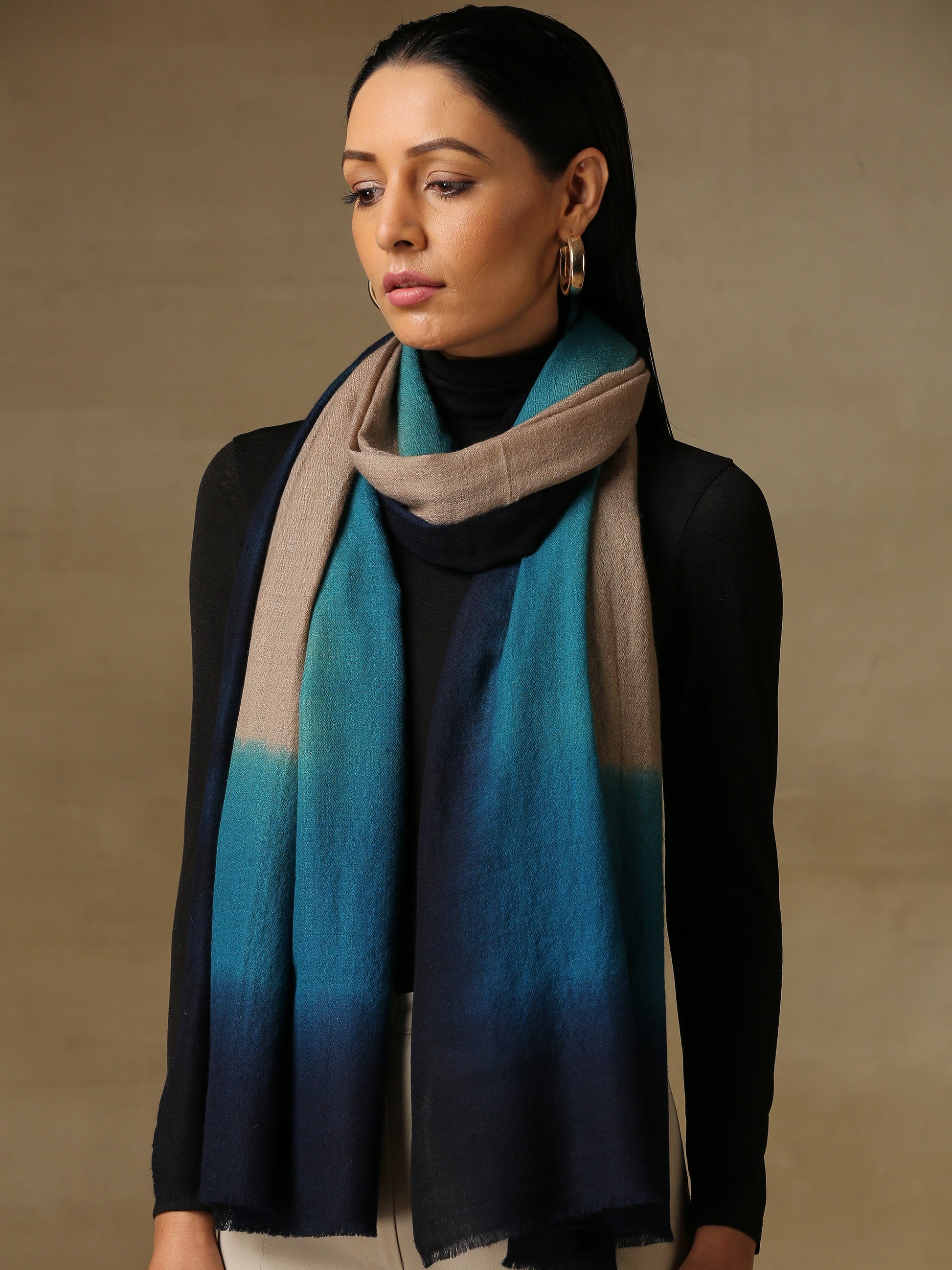Model is wearing a Saya Ombre stole from Shaza, in the colour Deep Sea: Toosh, gemstone blue and prussian blue. 