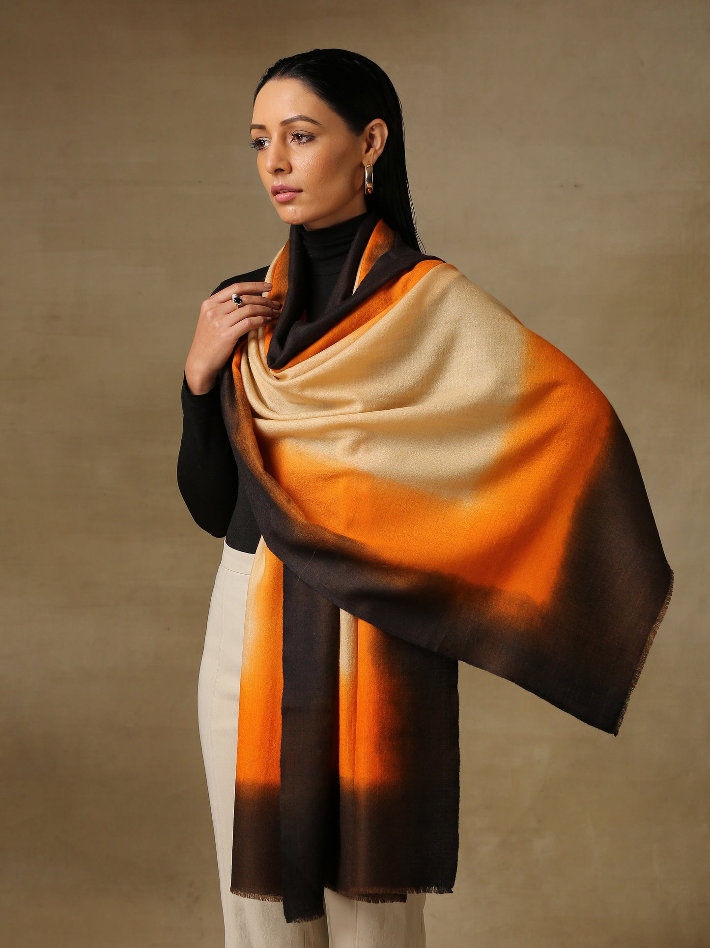 Model is wearing a Saya Ombre stole from Shaza, in the colour  Earth: Beige, orange and black
