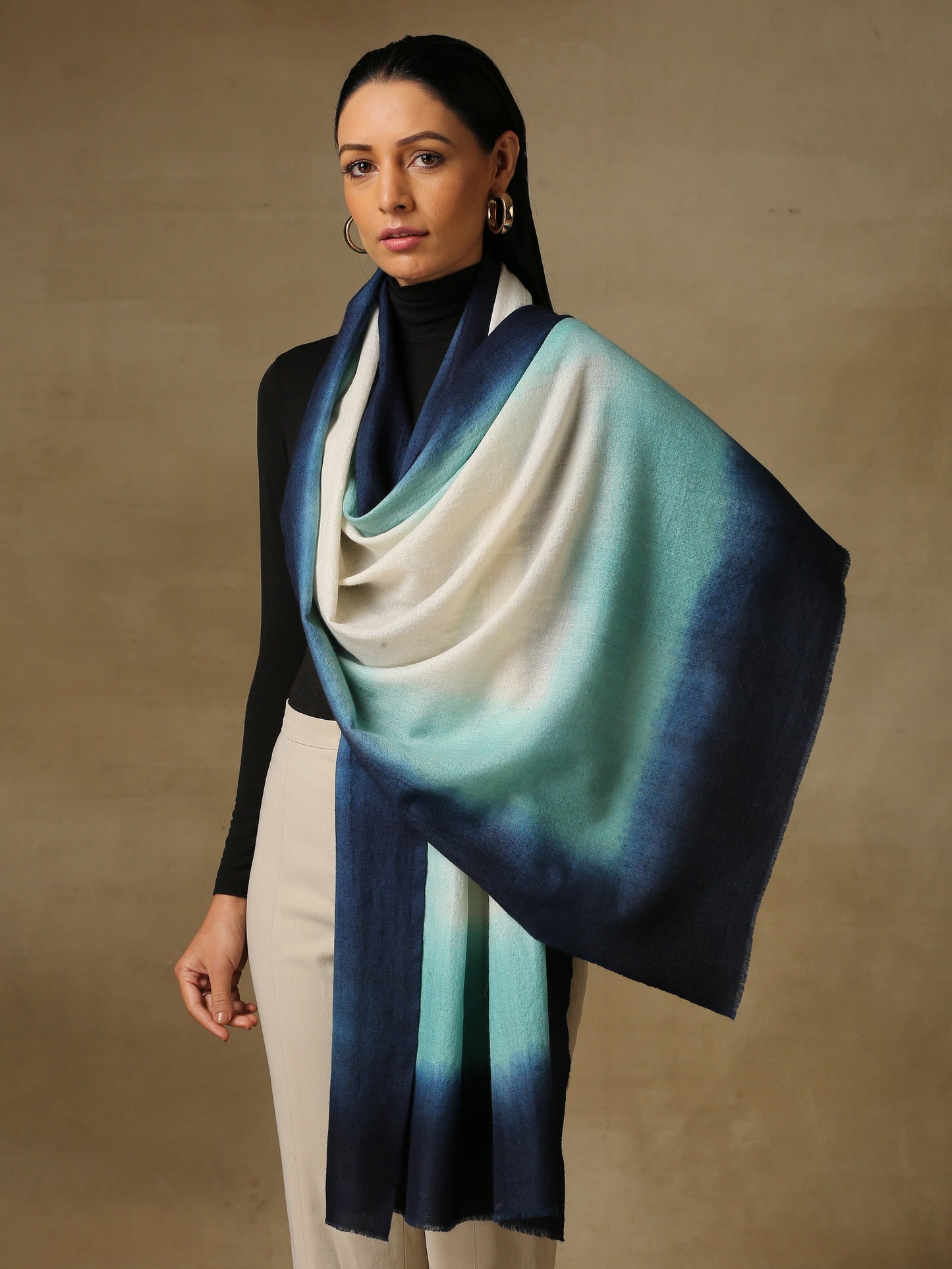 Model is wearing a Saya Ombre stole from Shaza, in the colour ocean : White, sea green and prussian blue. 