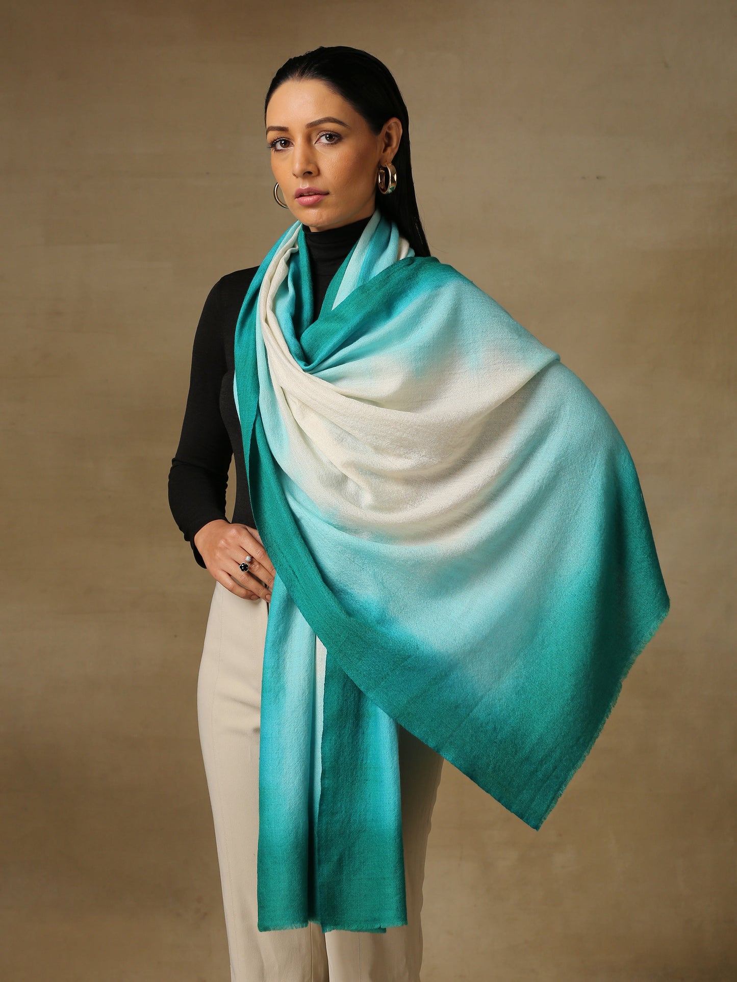 Model is wearing a Saya Ombre stole from Shaza, in the colour coral reefs : White, aqua and sea green.