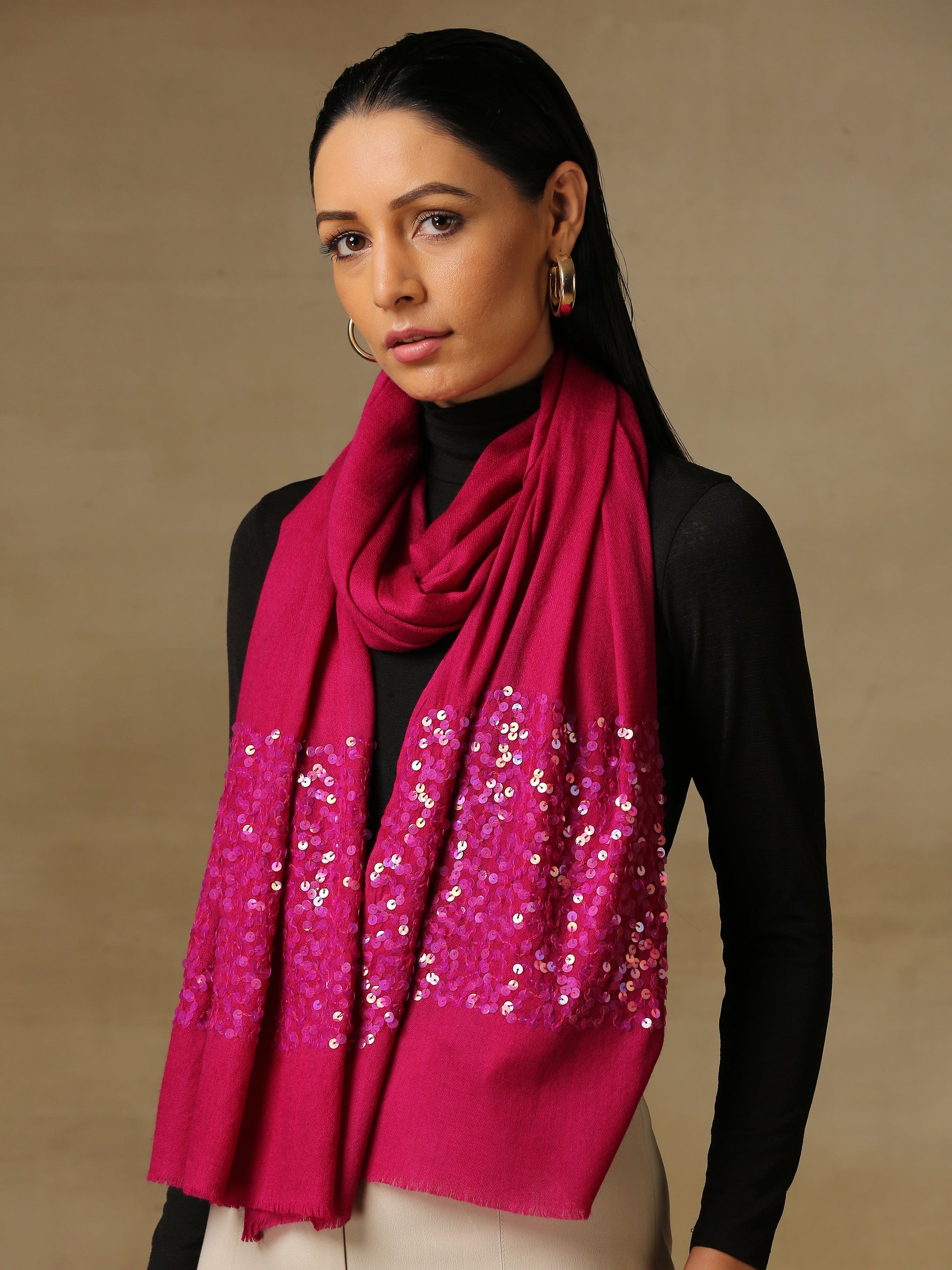Model is wearing a Shellwork stole from shaza with hand embellished shellwork, in the colour magenta.. 