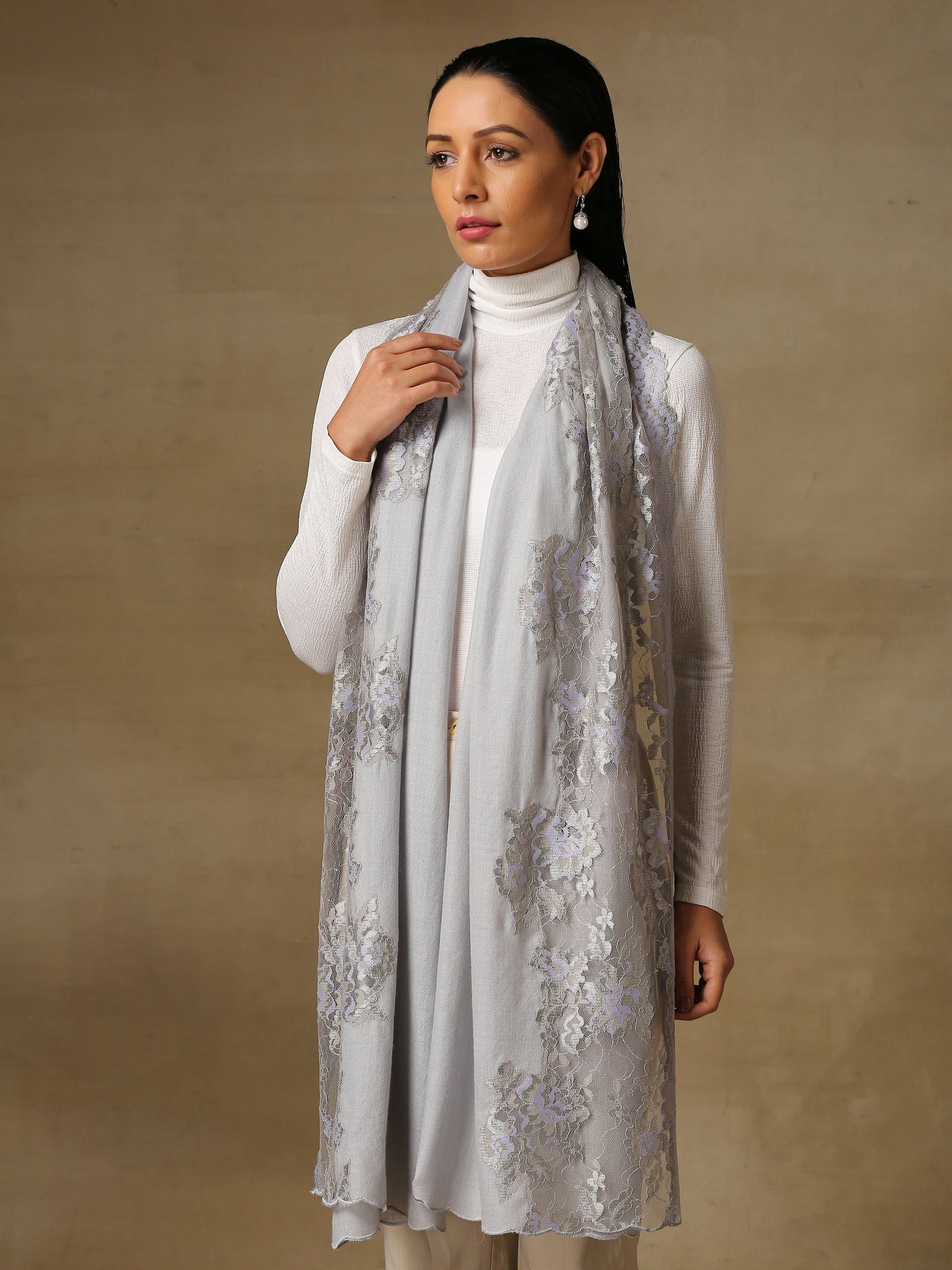 Model is wearing a Pashmina celestial chantilly stole in the colour lavender. 