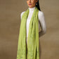 Model is wearing a Vineyard stole in the colour lime green, featuring vine shaped cutwork and zari detailing. 