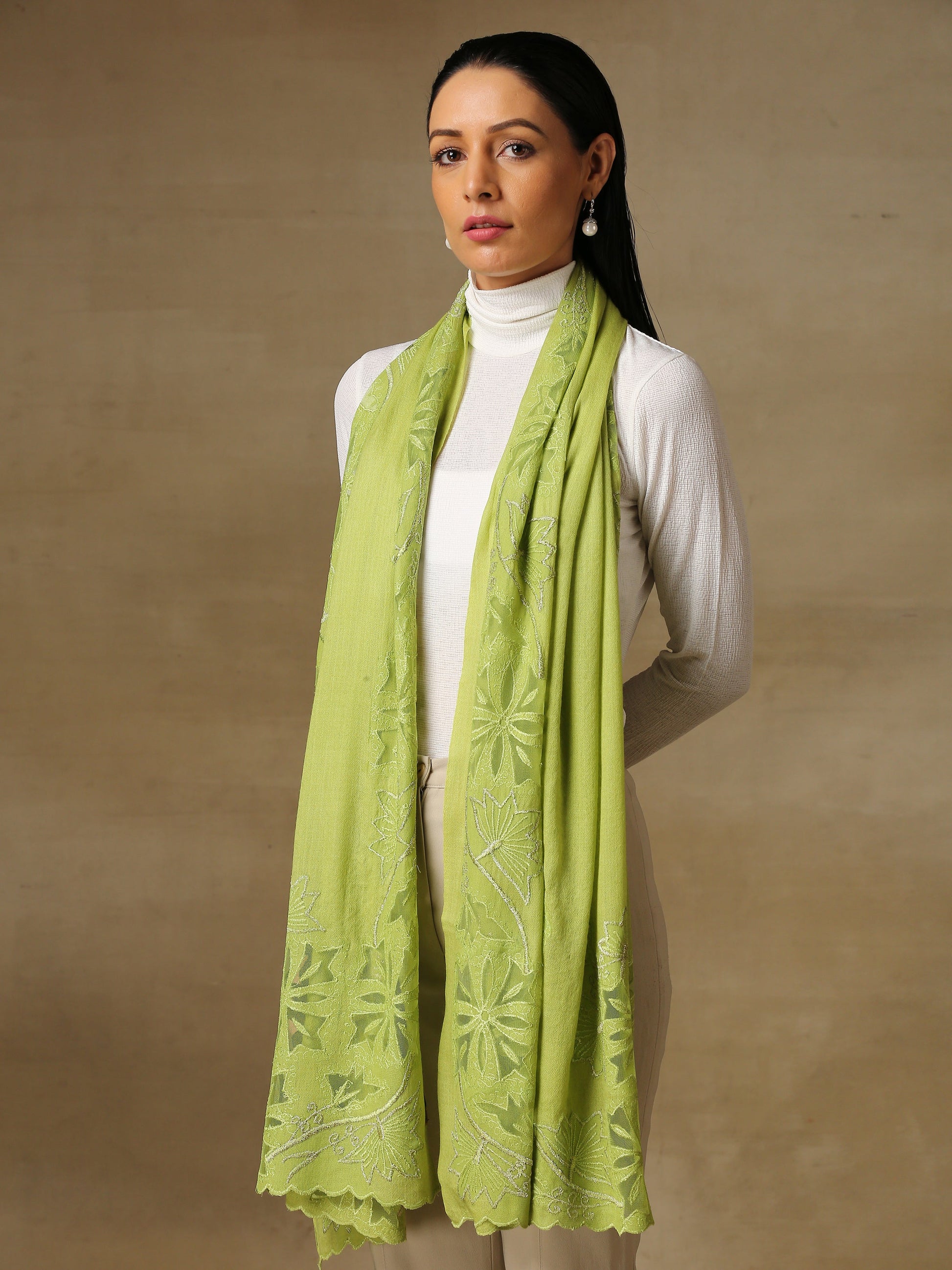 Model is wearing a Vineyard stole in the colour lime green, featuring vine shaped cutwork and zari detailing. 