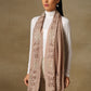 Model is wearing a Vineyard stole in the colour fawn, featuring vine shaped cutwork and zari detailing. 