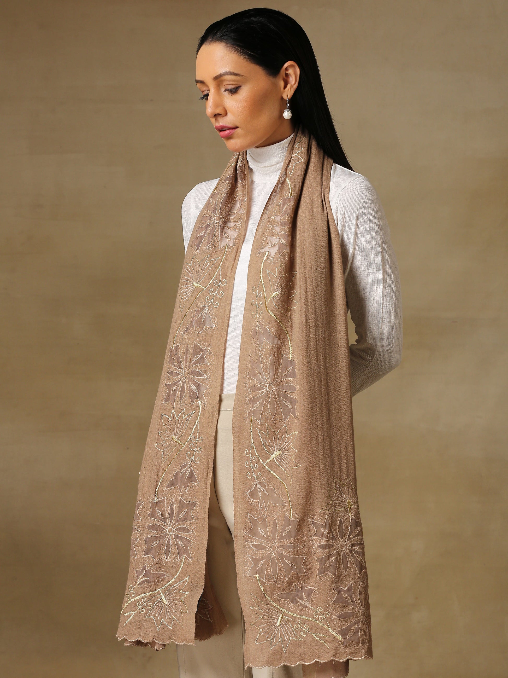 Model is wearing a Vineyard stole in the colour nude, featuring vine shaped cutwork and zari detailing. 