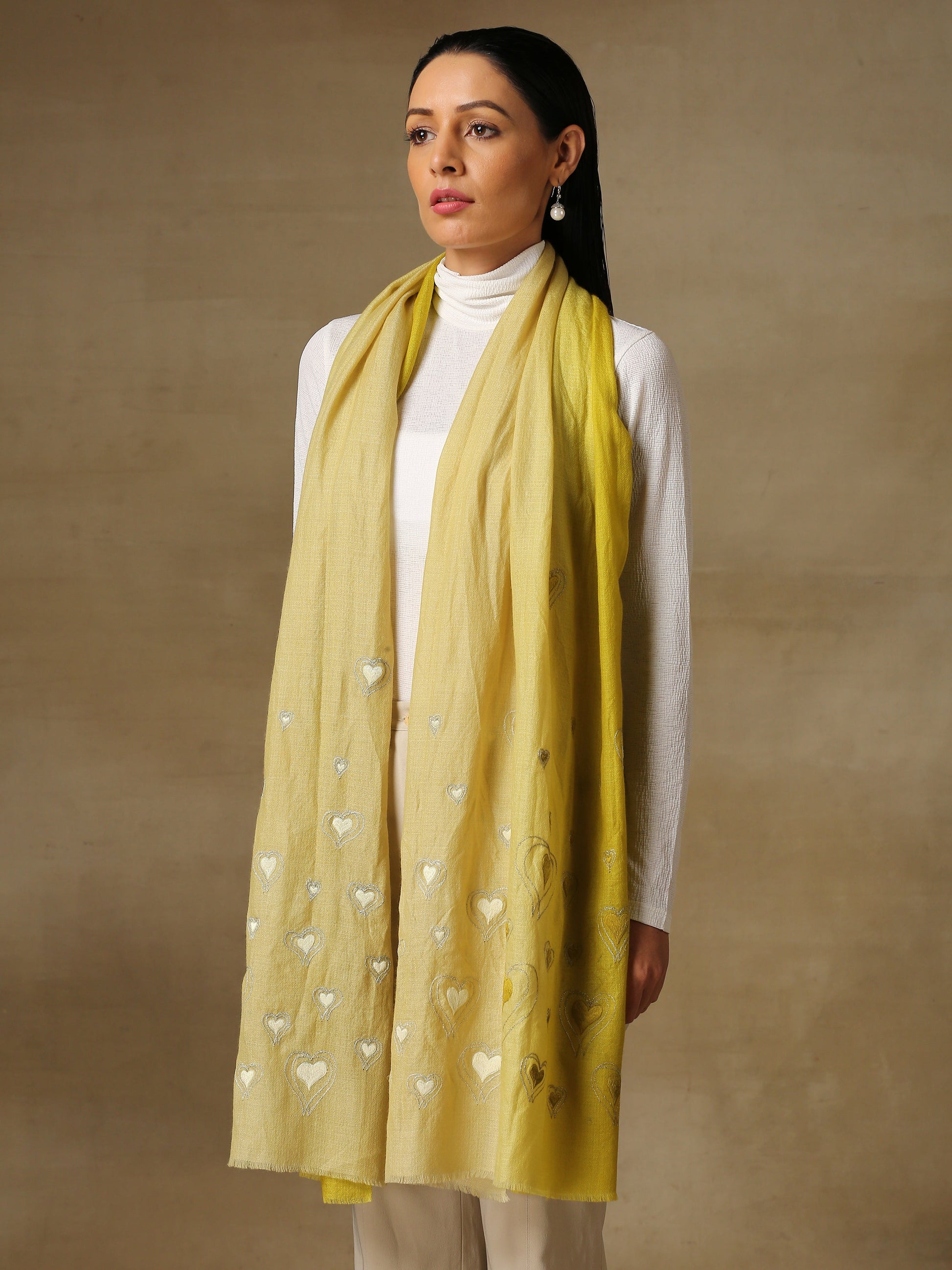 Model is wearing the Love tales pashmina stole in pista green from shaza, hand embroidered with heart shaped threadwork. 