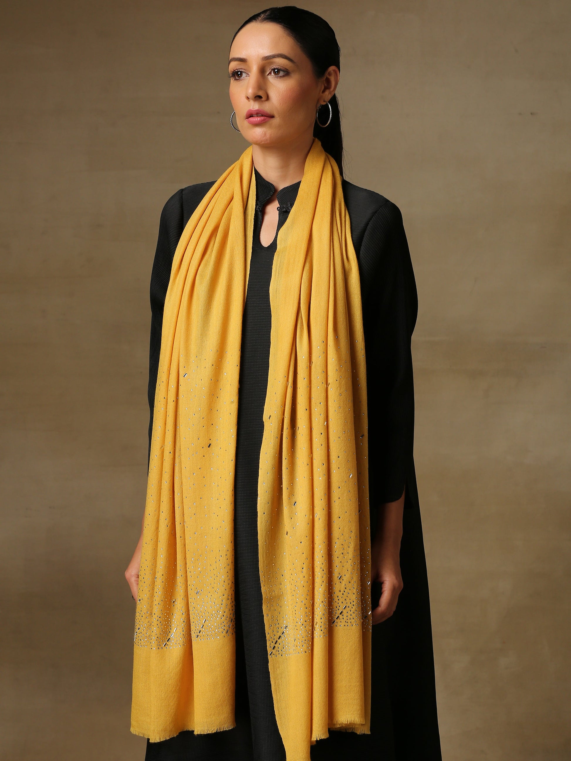 Model is wearing a swarovksi studded Era of Zaywar Palla Stole in the colour yellow. . 