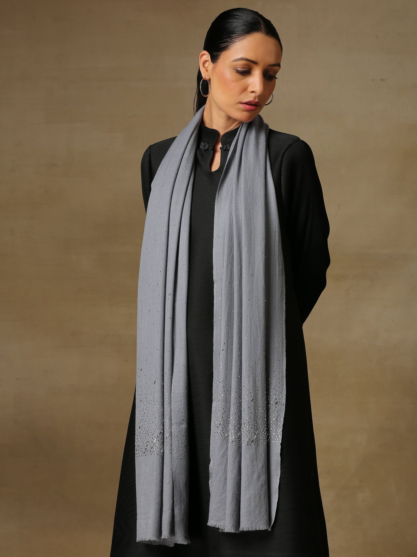 Model is wearing a swarovksi studded Era of Zaywar Palla Stole in the colour gray.. 