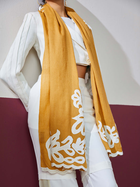 Model is wearing a mustard Velvet affair cashmere stole with white applique from Shaza.