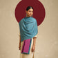 Model is wearing pashmina reversible shawl in pink with blue at the back.