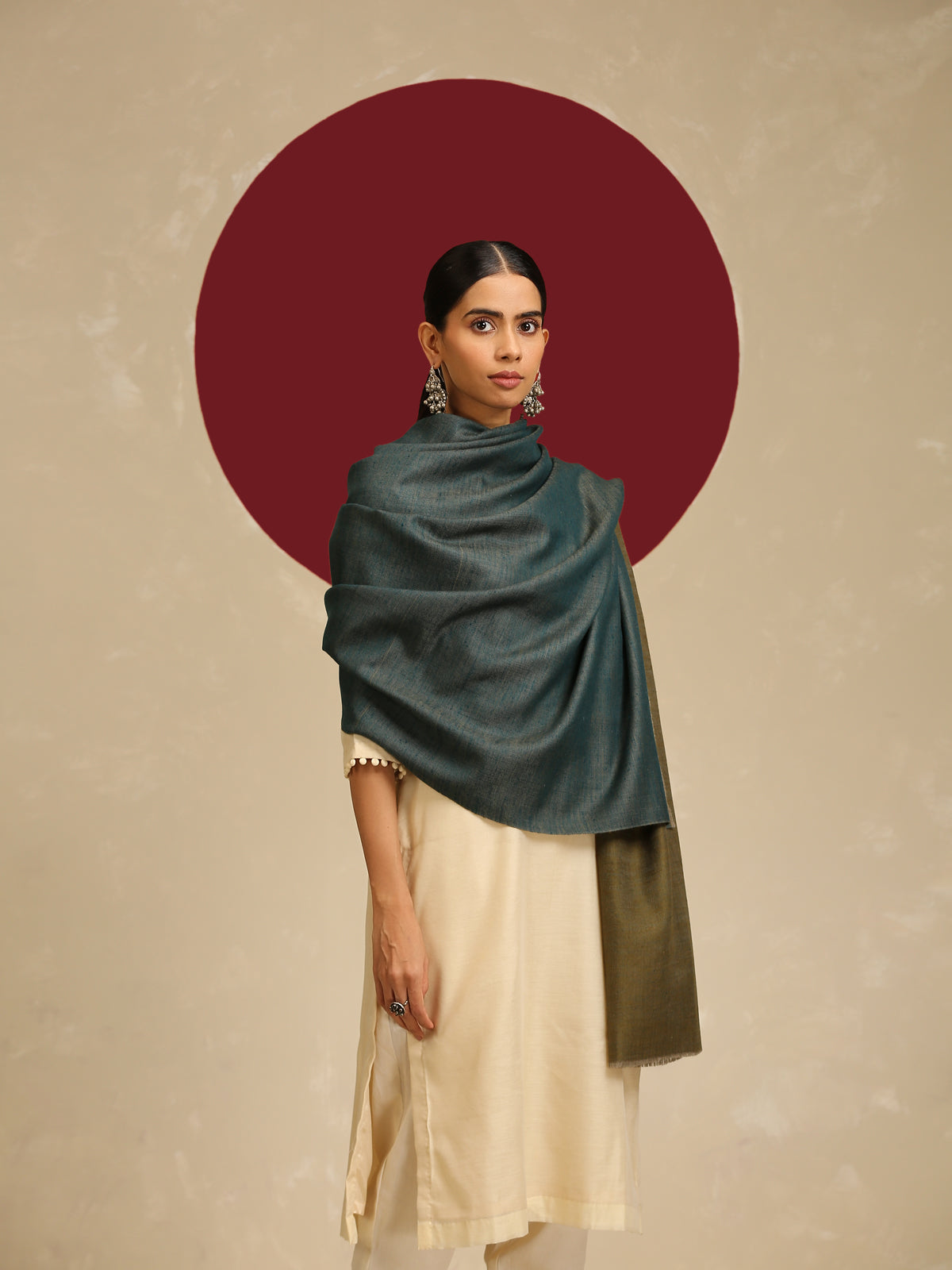 Model is wearing pashmina reversible shawl in olive with blue at the back.