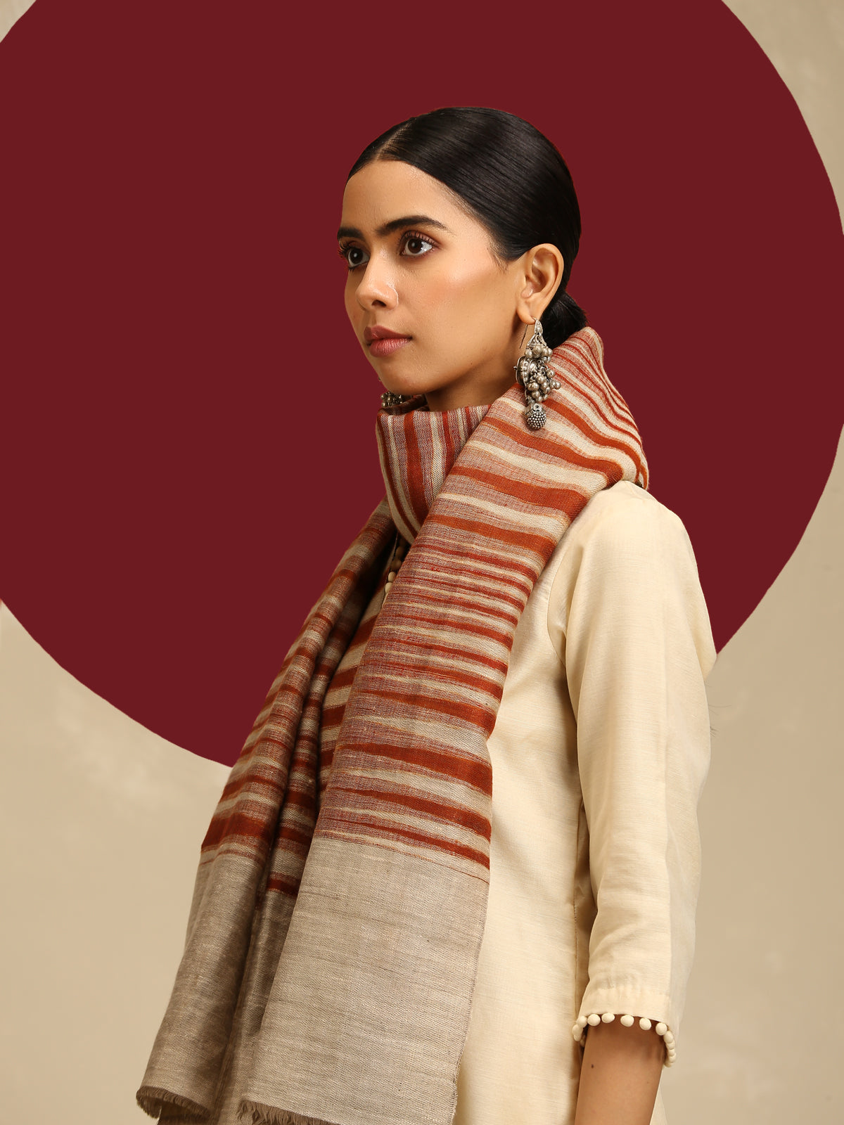 Model is wearing Ekkat reversible stole in a rust with gold zari backing. 