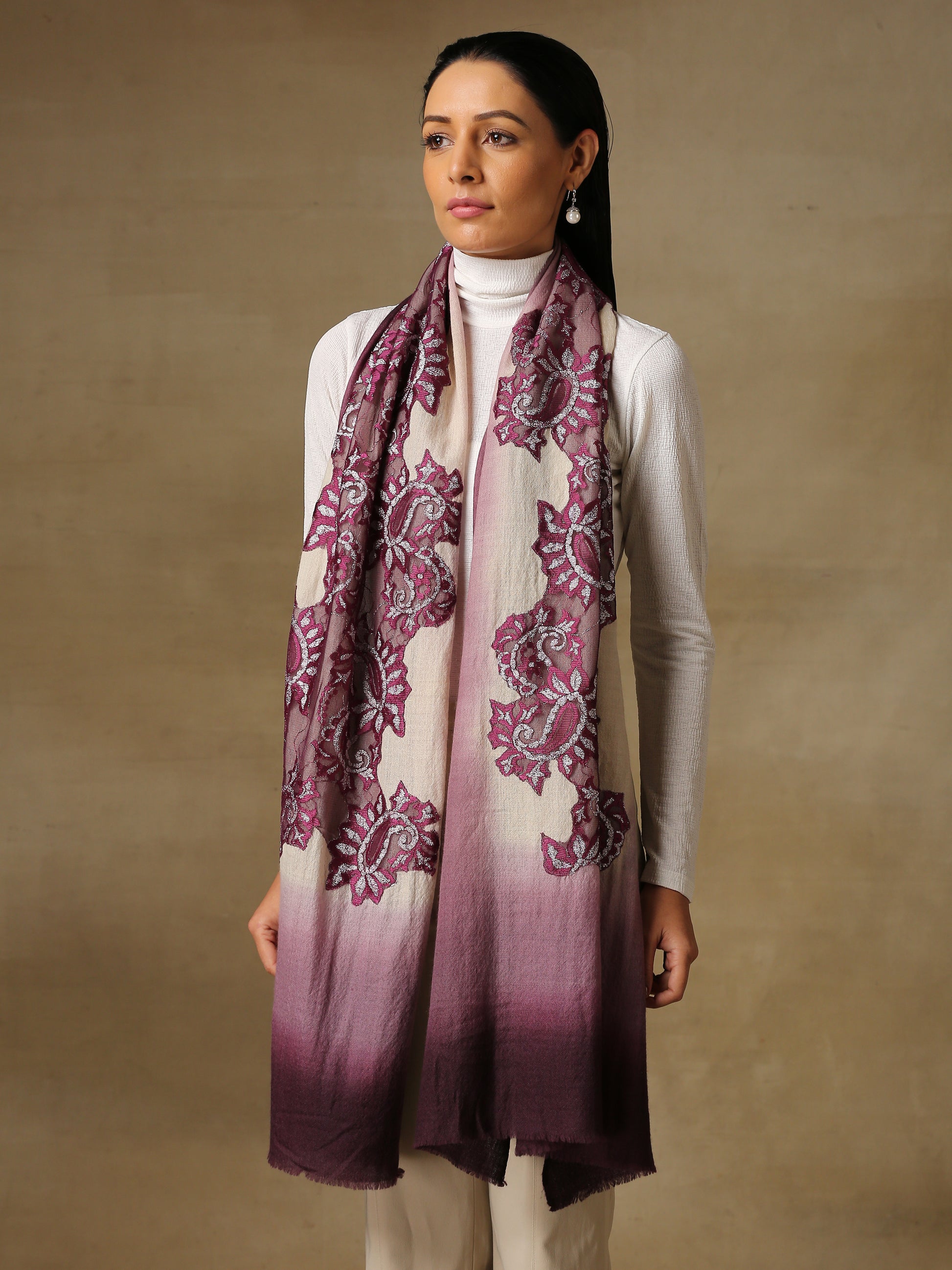 Model is wearing a Pashmina celestial chantilly stole in the colour orchid. 