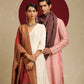 Model is wearing pashmina reversible shawl in red with gold at the back.