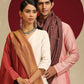 Model is wearing pashmina reversible shawl in red with gold at the back.