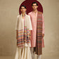 The model on the left is wearing a Pashmina Striped stole from shaza in a multicoloured stripes pattern on a white base. 