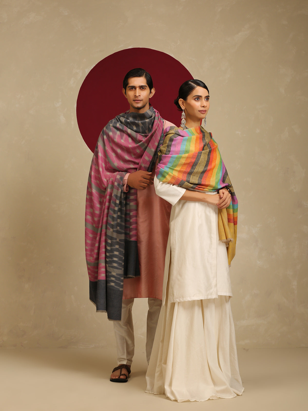 The model on the right is wearing a Pashmina stripe stole from Shaza in a multicoloured stripes pattern on a yellow base. 