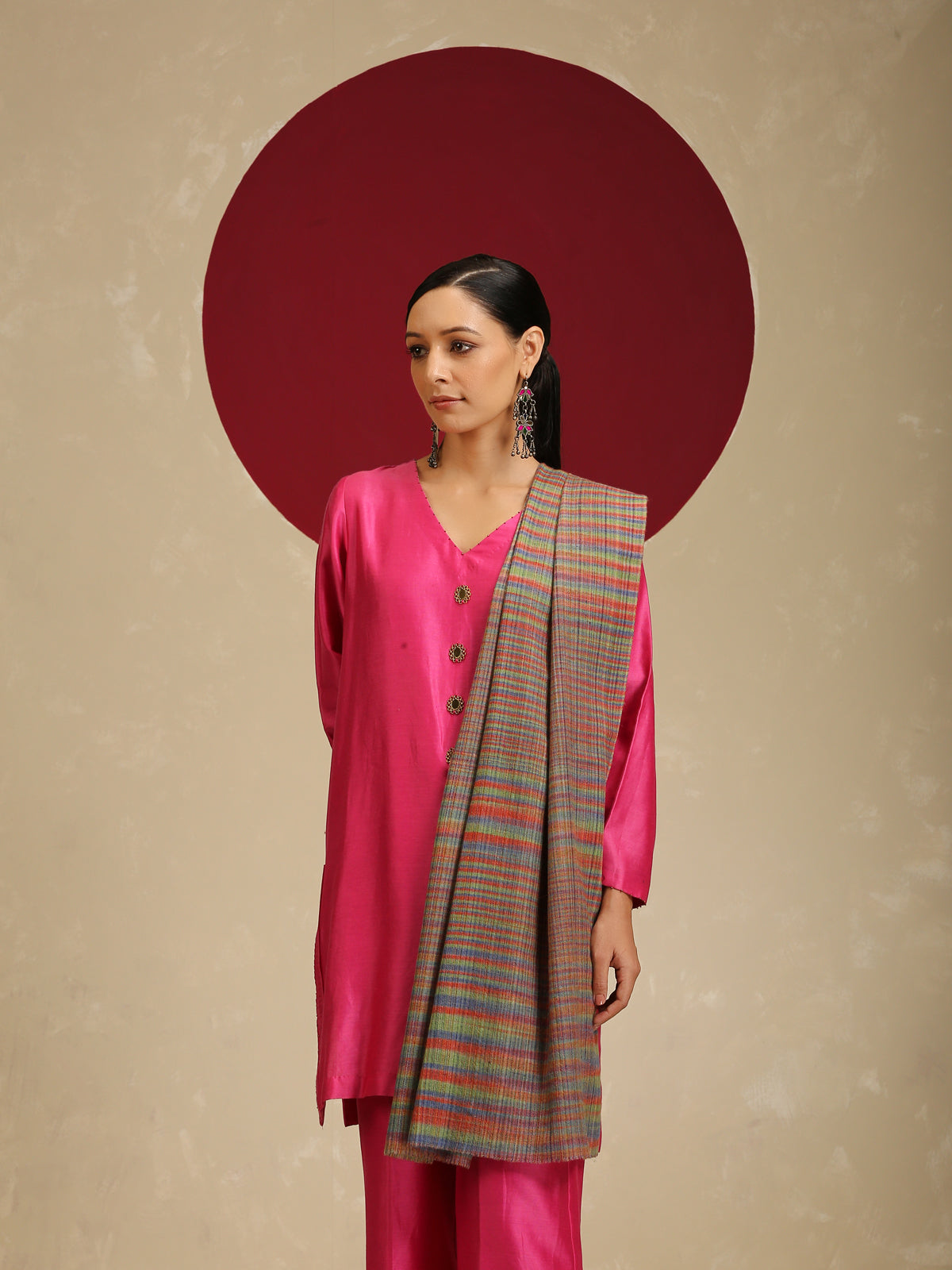 Model is wearing a Pashmina Striped stole from Shaza with multicoloured lines on a brown base. 