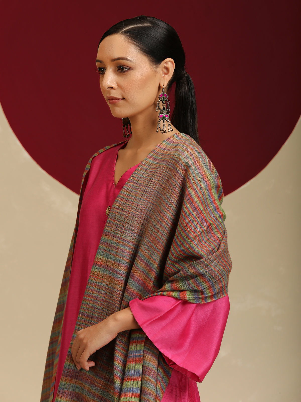 Model is wearing a Pashmina Striped stole from Shaza with multicoloured lines on a brown base. 