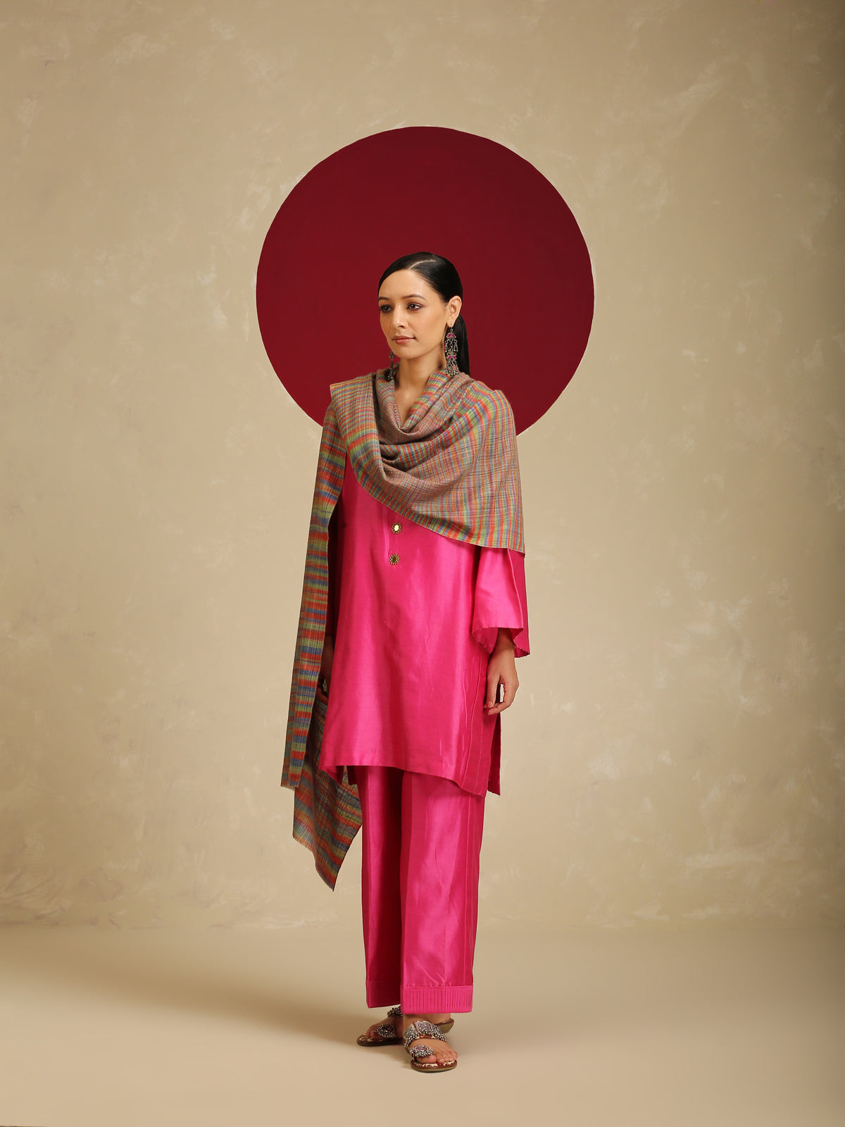 Model is wearing a Pashmina Striped stole from Shaza with multicoloured lines on a brown base. 