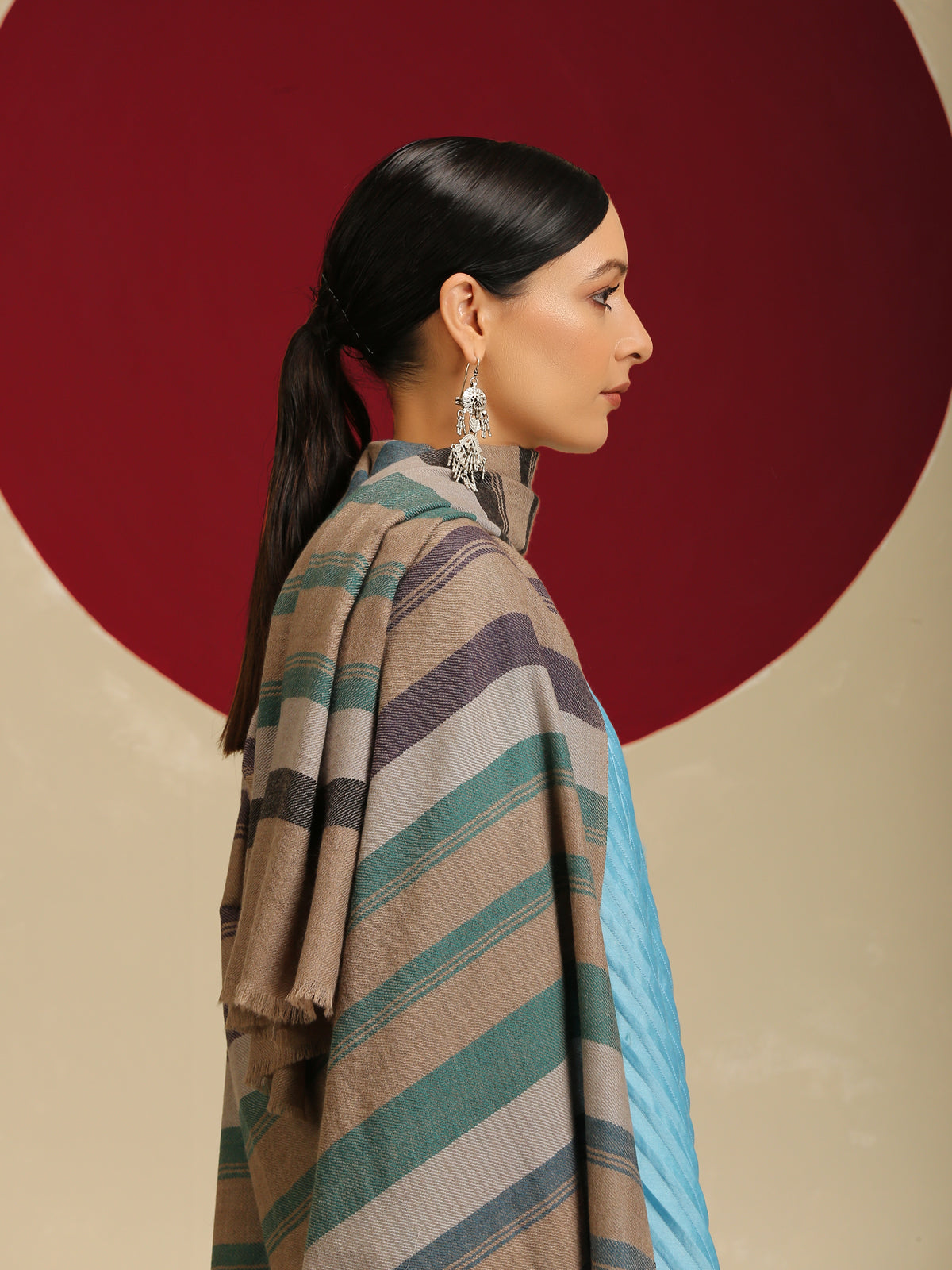 Model is wearing a Pashmina check stole in green and purple stripes.