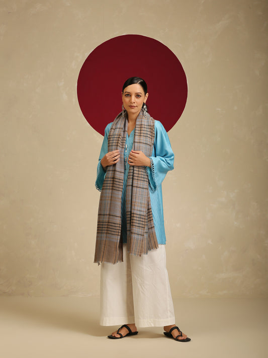 Model is wearing a Pashmina Check stole from Shaza with black and blue cross lines on a toosh coloured base. 