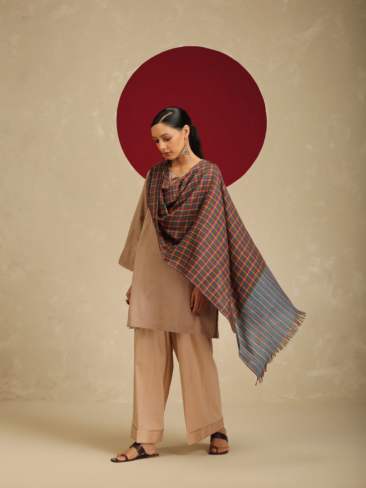 Model is wearing a Pashmina Striped stole from shaza in a multicolour cheques pattern. 