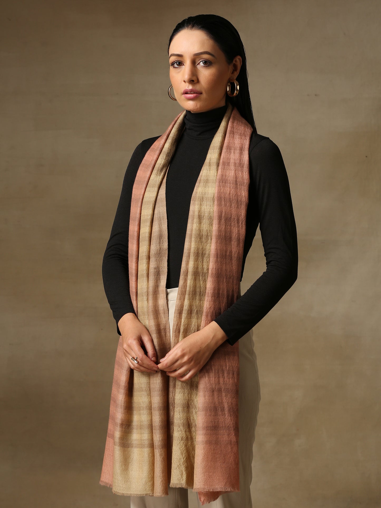Model is wearing pashmina ombre in self weave stole in colours of blush pink and fawn.