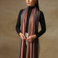 Model is wearing a Pashmina ombre stole in self weave in the colour dusky orange. 