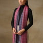 Model is wearing a Pashmina Ombre stole in self weave in the colours gray, pink & purple. 