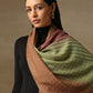 Model is wearing a Pashmina Ombre stole in a self weave in a pista green and mauve colour. 